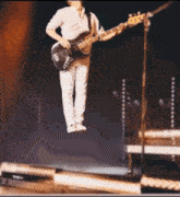 a man playing a bass guitar in the air