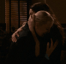 two women hugging each other with one wearing a ring