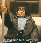 a woman is sitting on a subway train with her eyes closed .