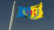 a blue and yellow flag with a red cross and laurel wreath