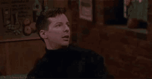 a man is sitting in a bar with the words `` excuse me ! rudeness ! '' written on the screen .
