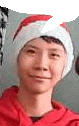 a young man is wearing a santa hat and smiling .