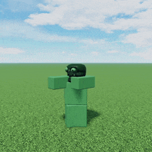 a green block with a black head is standing in a field