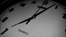 a close up of a quartz clock with the hands on the numbers 1 and 12