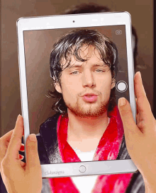 a tablet with a picture of a man on the screen