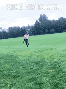 a shirtless man running in a field with the words ride his dick written above him