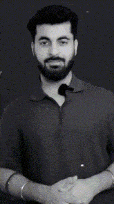 a man with a beard is smiling and giving a thumbs up