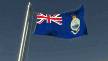 a blue flag with a british flag and a ship on it