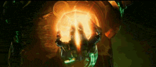 a person holding a glowing object in their hands in a dark room