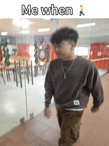 a boy walking in a hallway with the words me when on the bottom