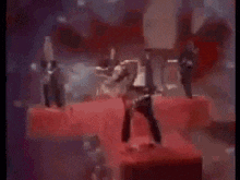 a group of people standing on top of a red cross ..