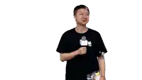 a man in a black shirt is holding a microphone and a piece of paper