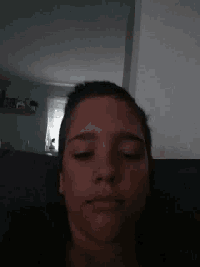 a man is laying on a couch with his eyes closed .
