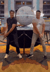 two men are standing in front of a star wars death star