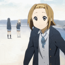 a girl in a school uniform with a blue bow tie