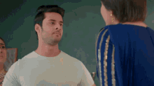 a man and a woman are standing next to each other