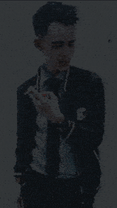 a man smoking a cigarette wearing a jacket that says nz on it