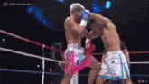 two boxers are fighting in a ring with oricon news written on the bottom right