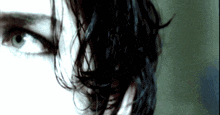 a close up of a person 's face with their hair visible