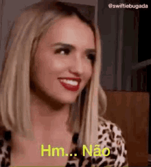 a woman in a leopard print shirt is smiling and saying hm .