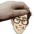 a hand is putting a donut on a man 's head with glasses .