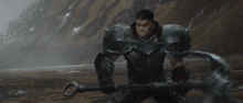 a blurry picture of a person holding a gun in front of a mountain