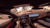 a person is driving a car with a gps screen on the dashboard