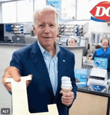 a man in a suit is holding an ice cream cone and a receipt at a dairy queen .