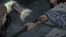 a man in a blue and white shirt is holding a stick with blood on his arm .
