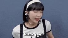 a girl wearing headphones and a headband is saying thank yeah .