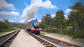 a thomas the tank engine train is going down train tracks .