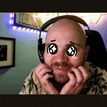 a bald man wearing headphones has a sticker on his face that says ' i love you '