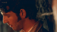 a man and a woman are looking at each other with the bbc logo visible