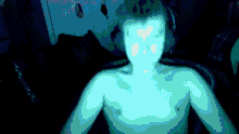 a man without a shirt is glowing blue in the dark