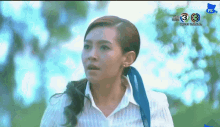 a woman in a white shirt stands in front of a tv screen that says hd 3