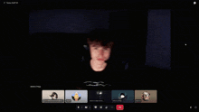a man wearing a headset is on a video call with a group of people