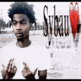 a man in a white shirt is giving the middle finger in front of a syeau logo