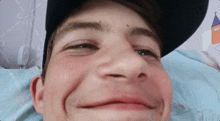 a close up of a man 's face wearing a baseball cap