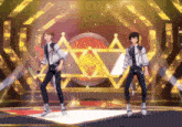two anime characters are dancing on a stage in front of a star