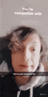 a young boy is making a funny face and says you 're compatible with we 're just mean to be