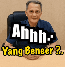 a man sits at a desk with the words ahhh- yang beneer written on the bottom