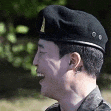 a close up of a man in a military uniform wearing a black beret .