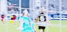 a blurry picture of a soccer game with a player wearing the number 1