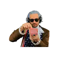 a man in a wig and sunglasses is holding a stack of red playing cards