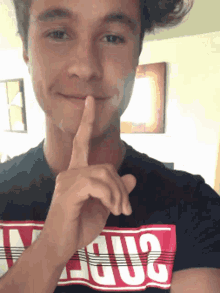 a young man wearing a t-shirt that says ' jesus ' on it