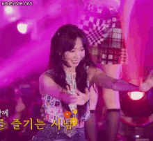 a woman is dancing on a stage with purple lights behind her and the words honeycam.org on the bottom