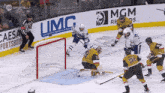 a hockey game is being played in front of a large mgm sign