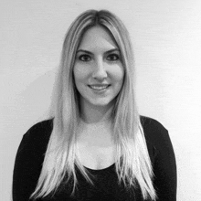 a woman with long blonde hair wearing a black shirt