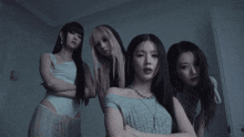 a group of women with their arms crossed are standing next to each other