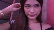 a woman taking a selfie with her hand on her hair